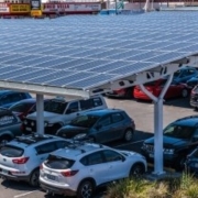 Solar panels placed over parking spaces are among the many options that can help companies get closer to their sustainability goals.