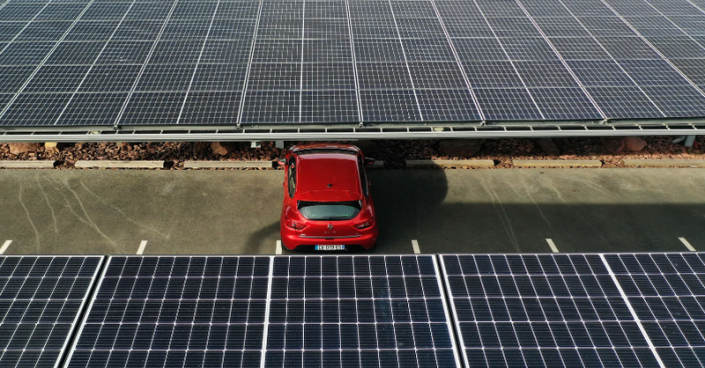 Solar panels over parking lots produce clean electricity without wasting space and provide shade in sunny, warm weather for drivers.