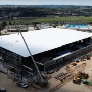 The new 7,500 capacity venue, Frontwave Arena, partners with Baker Electric for a renewable energy project, featuring solar array and storage